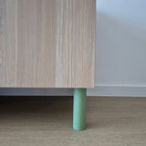 green cabinet leg