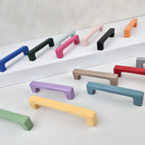 Set of colorful cabinet handles on a white background