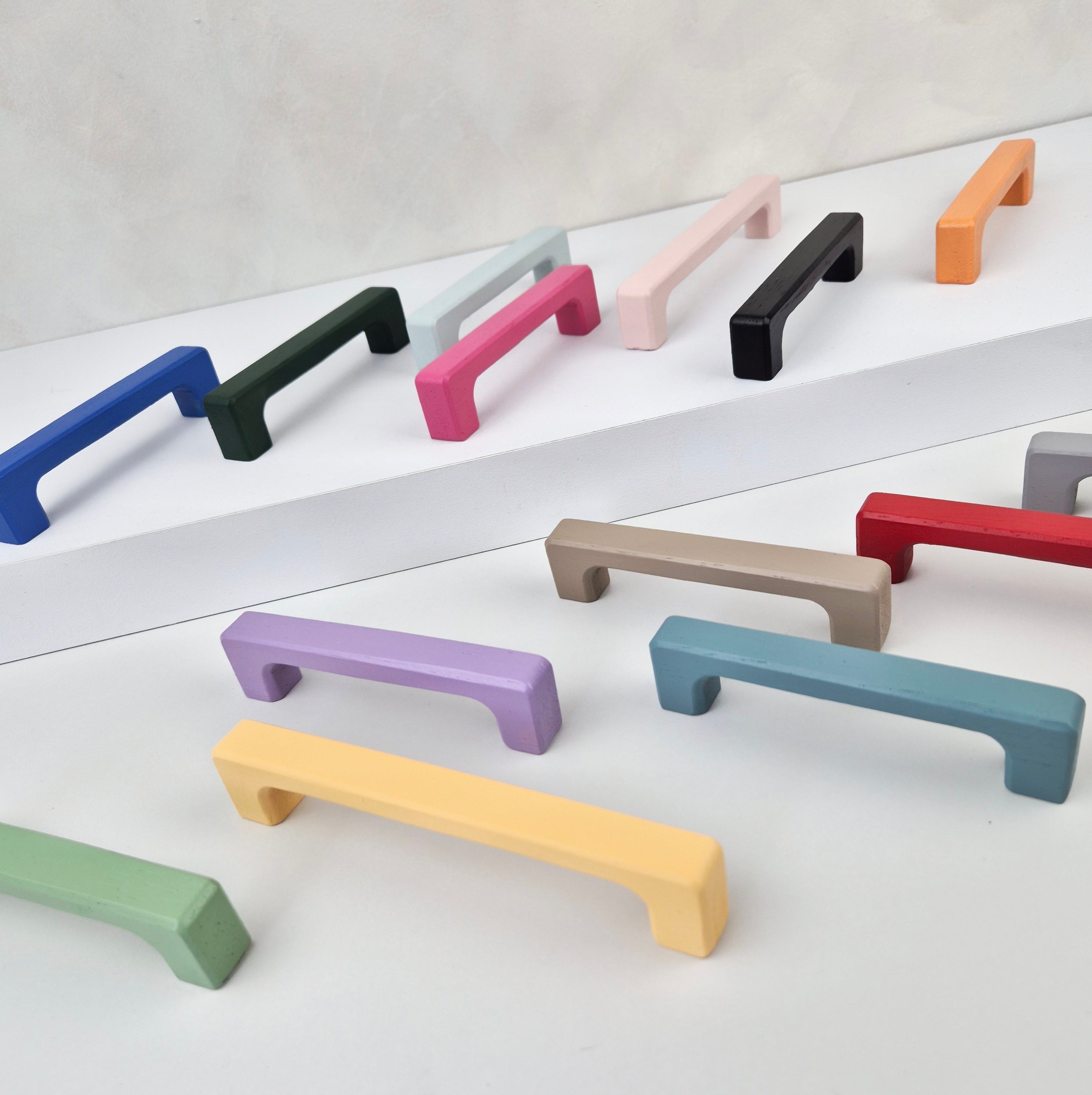 Set of colorful cabinet handles on a white background