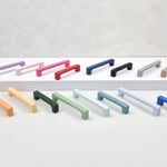 Set of colorful cabinet handles on a light gray background