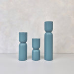 Three hourglass-shaped decorative vases in blue, showcasing modern design and perfect for home decor.