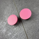 Pink knobs on the dark furniture doors