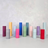 Colorful striped furniture legs in a variety of sizes and colors, showcasing unique designs for home decor.