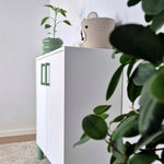 Green cabinet handles on white cabinet