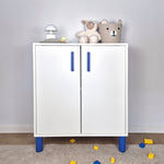 Blue cabinet handle on a stylish white storage cabinet in a kids' room with decorative items.