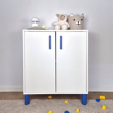 Blue cabinet handle on a stylish white storage cabinet in a kids' room with decorative items.