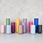 Colorful decorative vases in various shapes and hues including green, yellow, pink, blue, and purple.