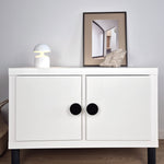 White cabinet with black knobs and legs