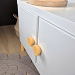 Flat round knob BALANCE in yellow on a white cabinet, adding a cheerful touch to kids' furniture with playful design.