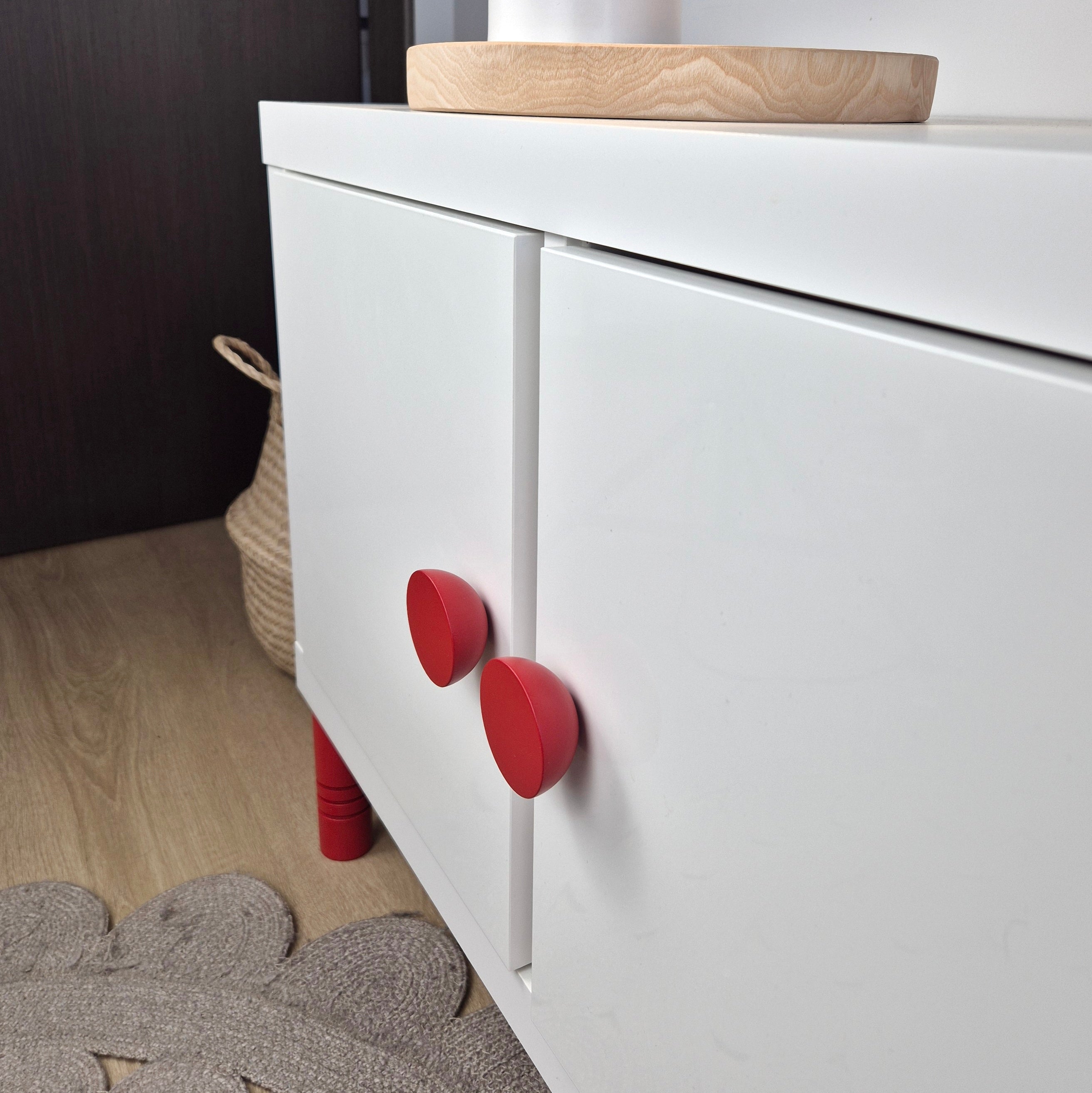 White cabinet with red round knobs