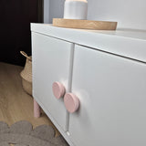White cabinet with pink knobs