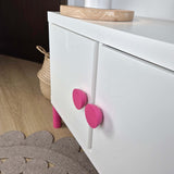 Pink round knob on IKEA Kallax cabinet