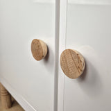 Birch wood round knob BALANCE on white cabinet door