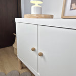 White cabinet with oak wood knobs