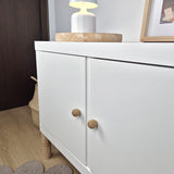 White cabinet with oak wood knobs