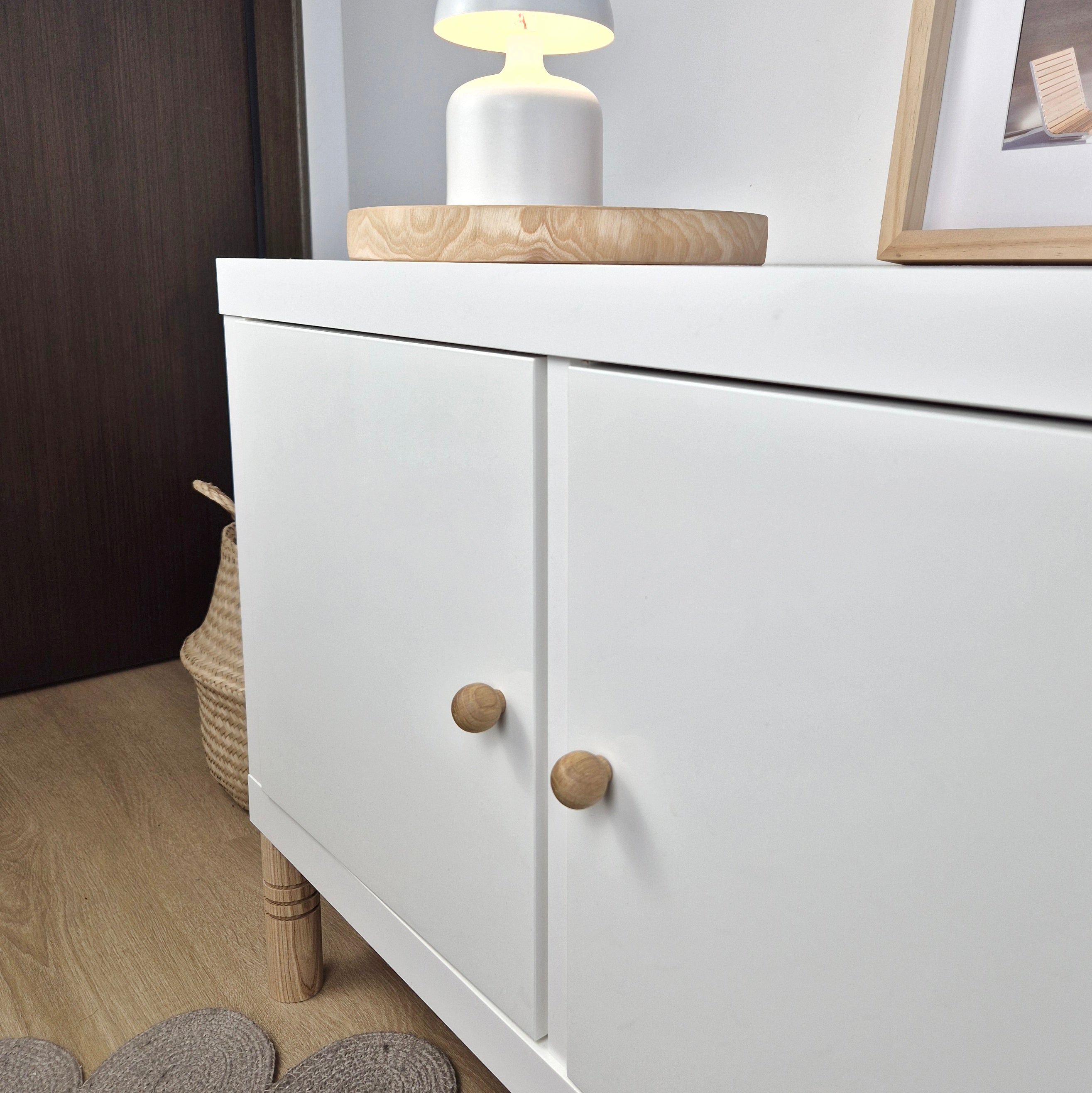 White cabinet with oak wood knobs