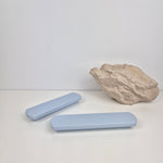 Two light blue rectangular handles and a rock on a white background