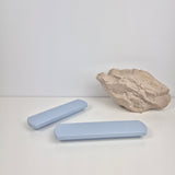 Two light blue rectangular handles and a rock on a white background