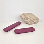 Two purple rectangular handles and a rock on a white background