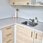 Kitchen with beige cabinet handles and knobs