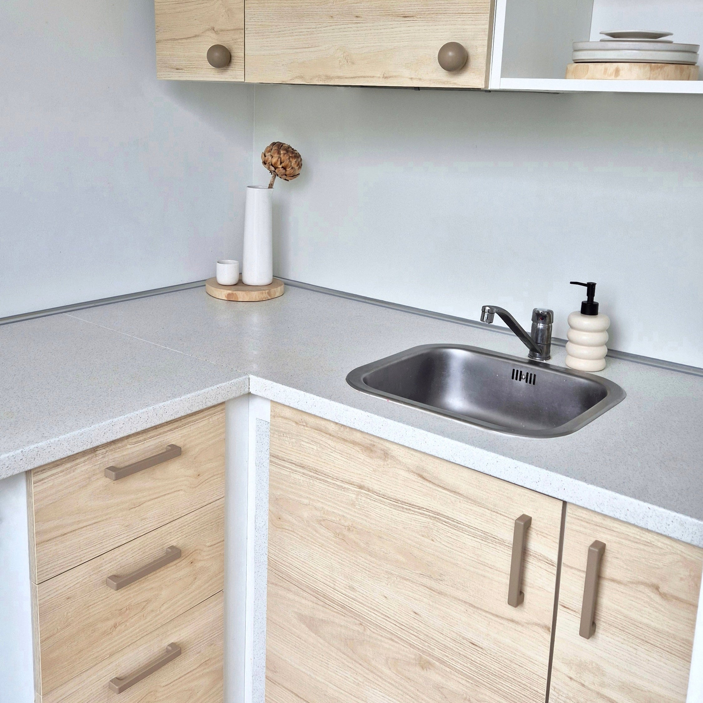 Kitchen with beige cabinet handles and knobs