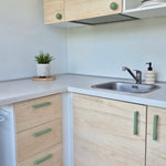 Green cabinet handles on kitchen furniture