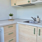 Green cabinet handles on kitchen furniture