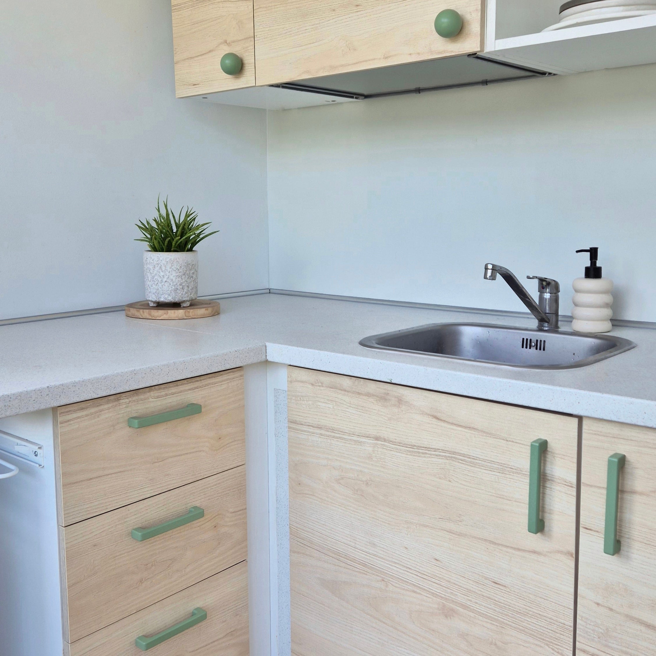 Green cabinet handles on kitchen furniture