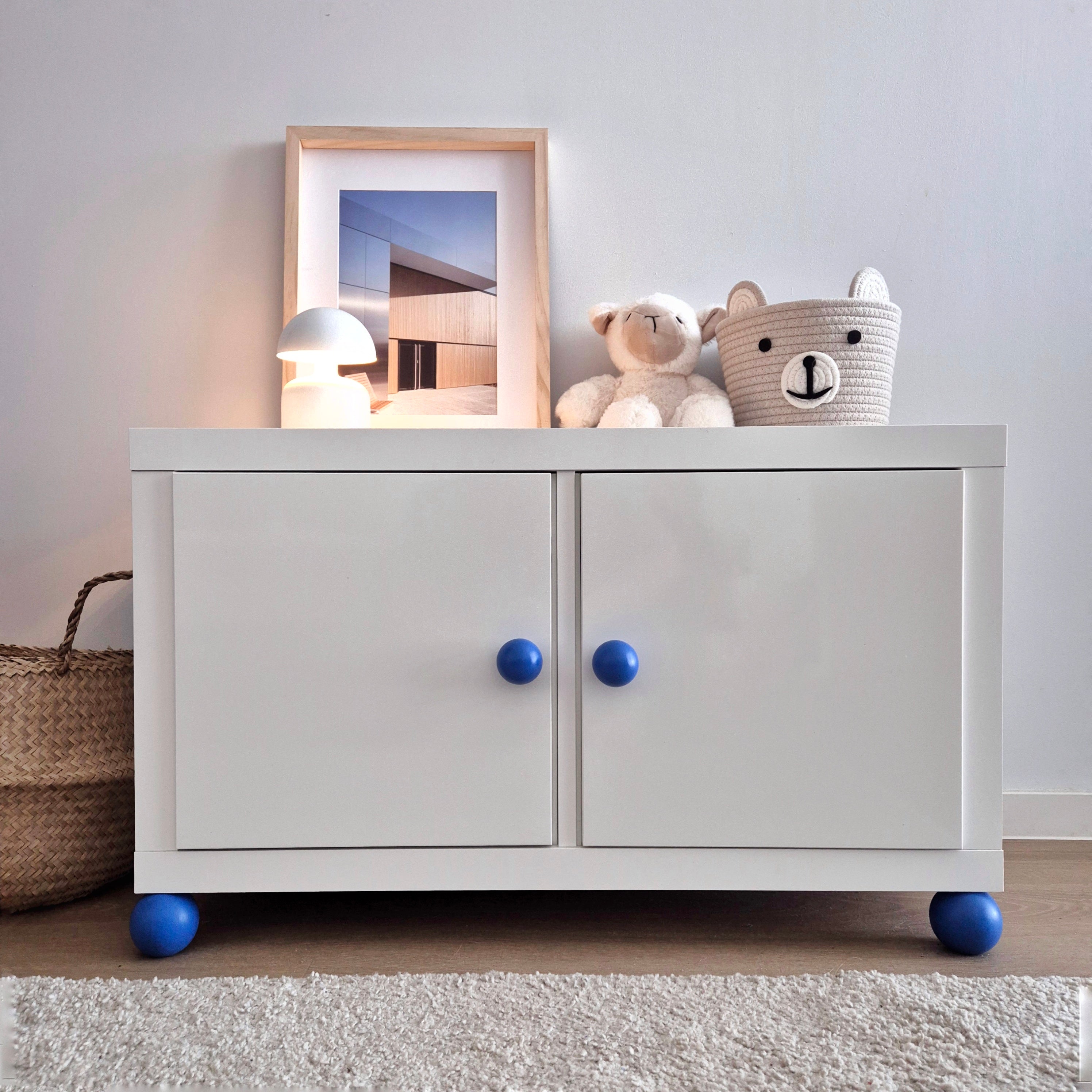 White IKEA Kallax cabinet with Round blue knobs