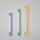 green, purple and yellow long thin cabinet handles