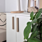 Beige L-Shaped Furniture Handles on white cabinet