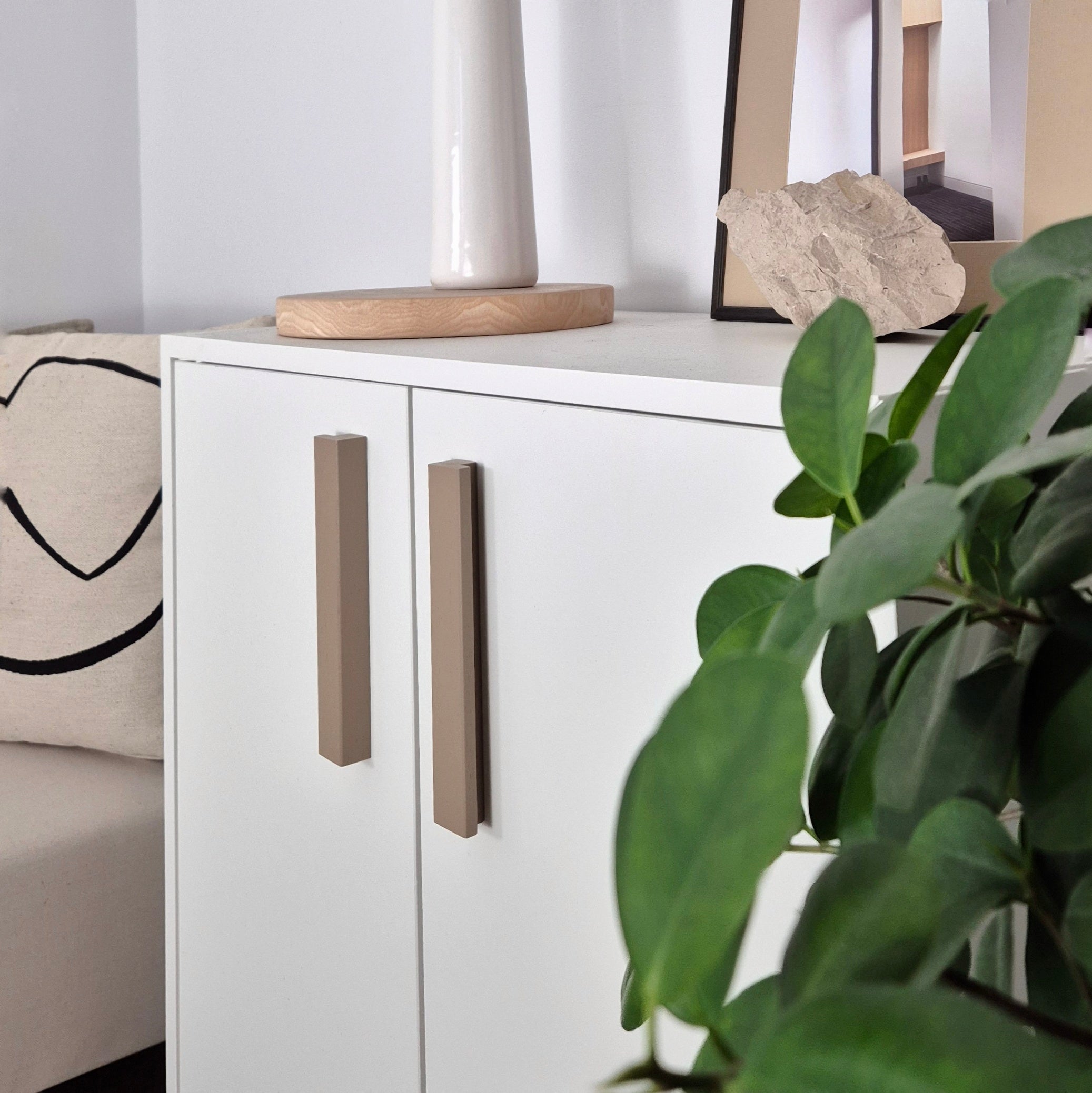 Beige L-Shaped Furniture Handles on white cabinet