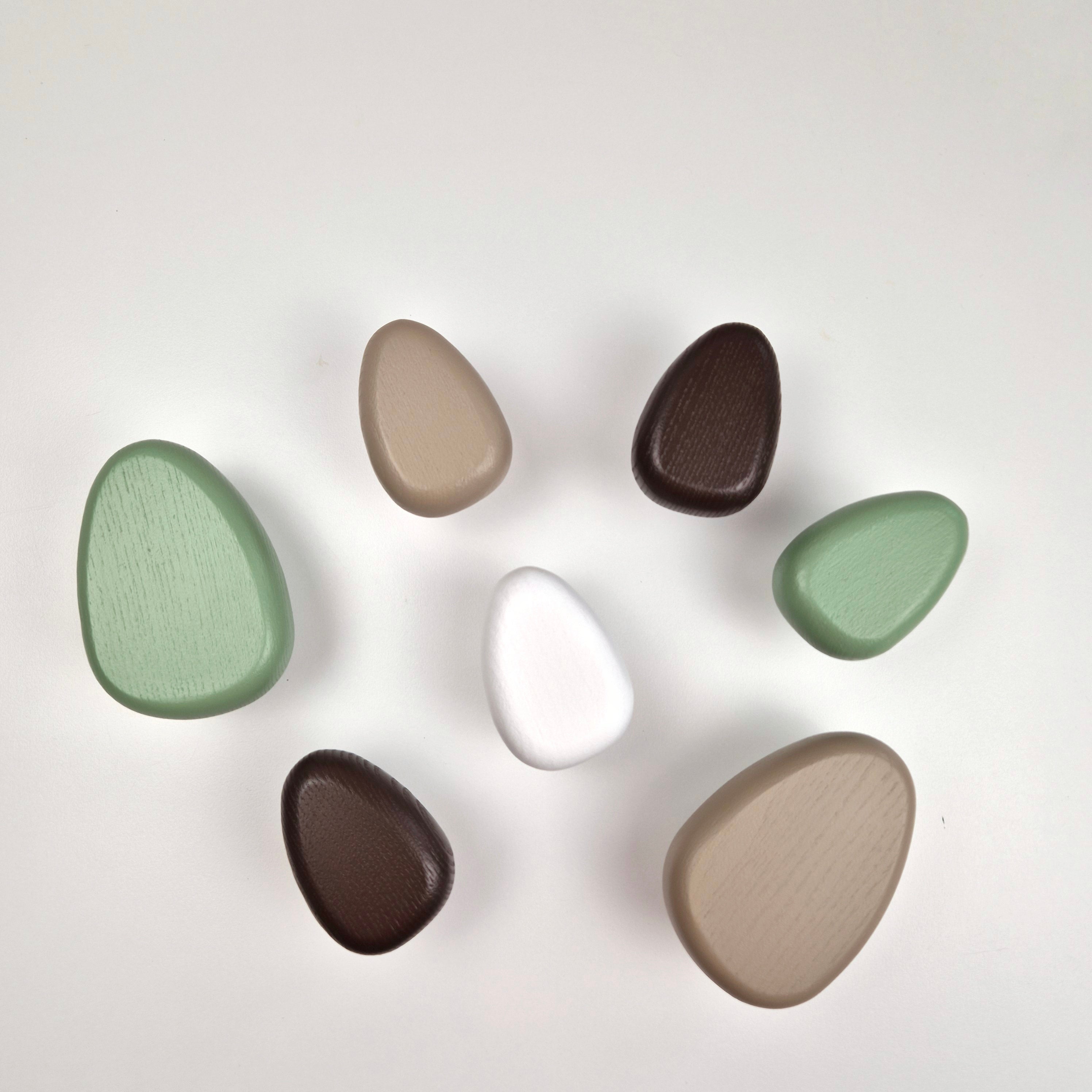green, white and Brown wall hooks