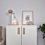 White cabinet with wooden furniture handle