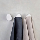 White wall hooks with linen towels