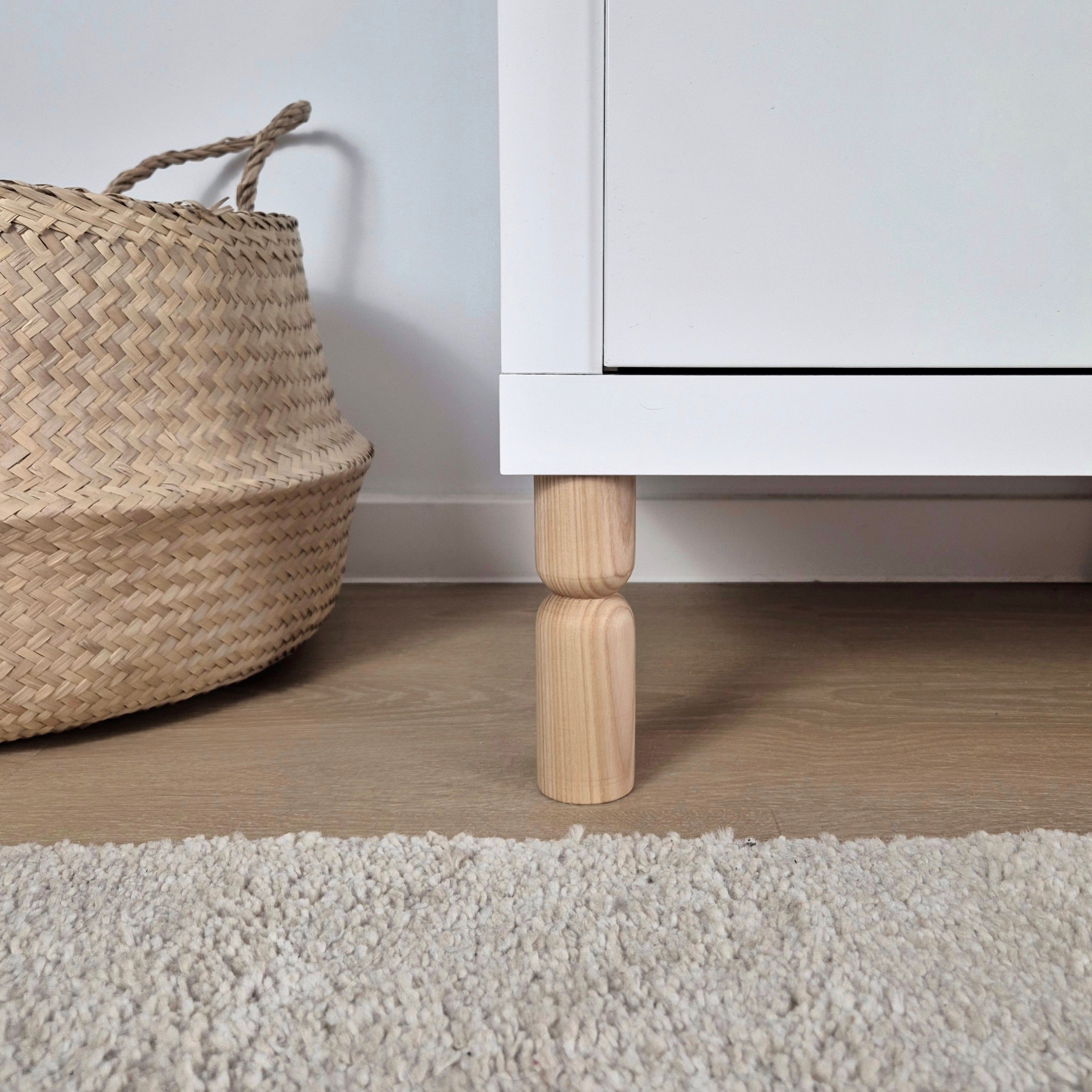 Wooden cabinet leg on white cabinet