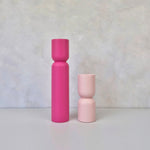 Pair of hourglass shaped decorative vases in pink and light pink, showcasing modern design for stylish home decor.