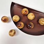 Round knob AMBER crafted from pressed amber, showcasing a perfect round shape and luxurious tones.