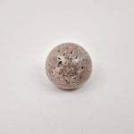 Grey natural stone drawer knob on wooden cabinet