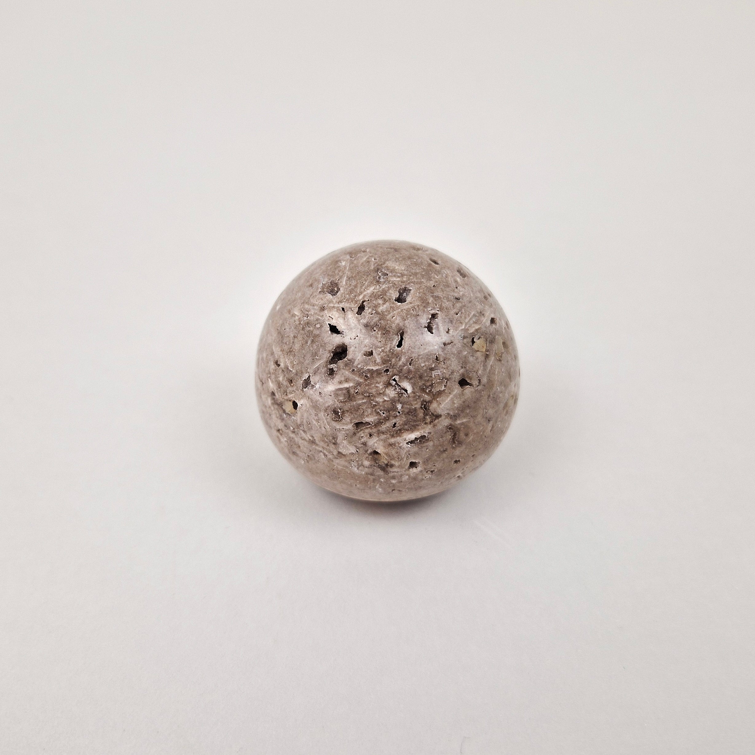 Grey natural stone drawer knob on wooden cabinet