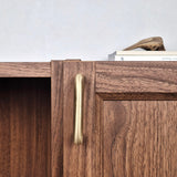 Brass cabinet pull showcased on a wooden cabinet, highlighting its elegant design and warm satin finish.