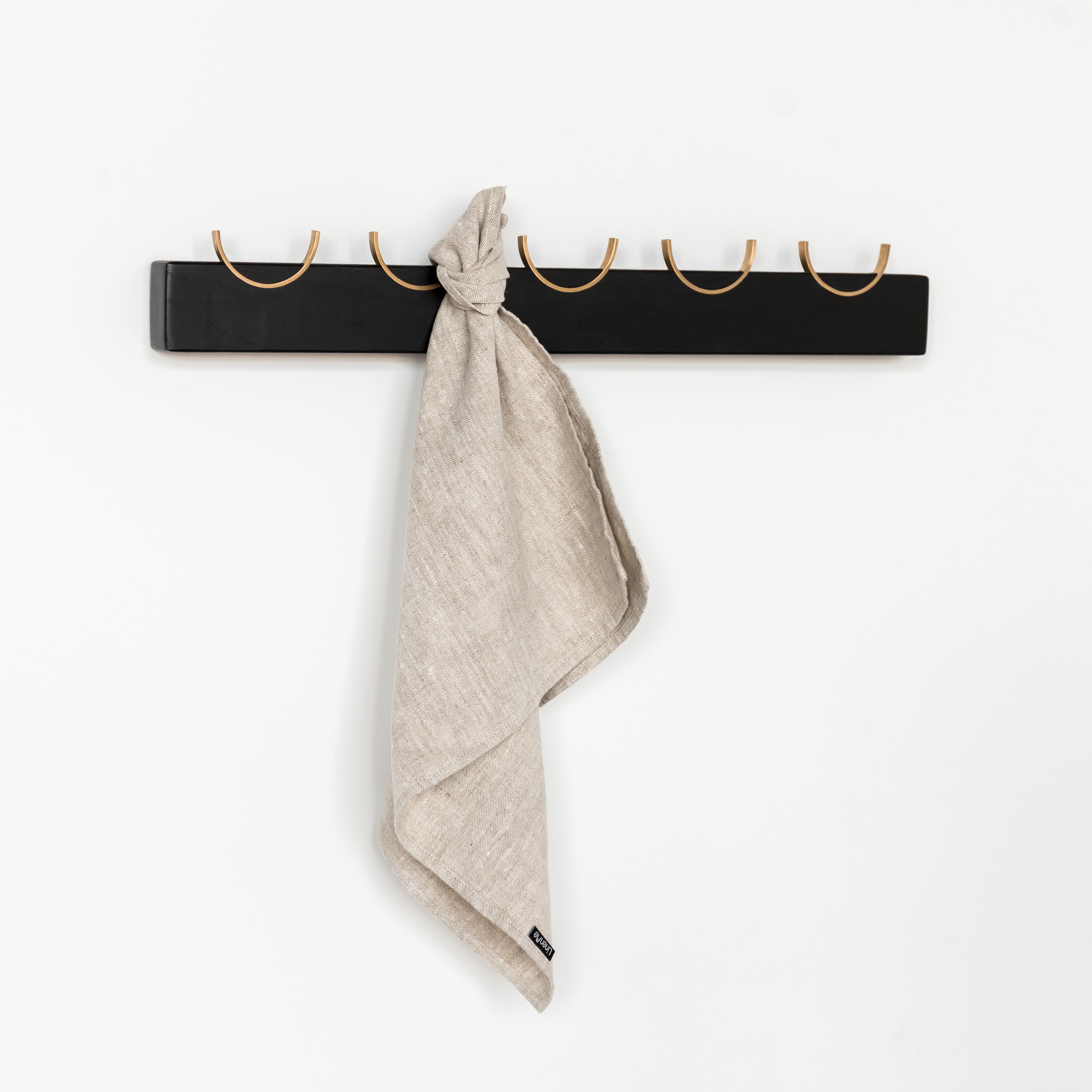 Black wall rack with brass for towels