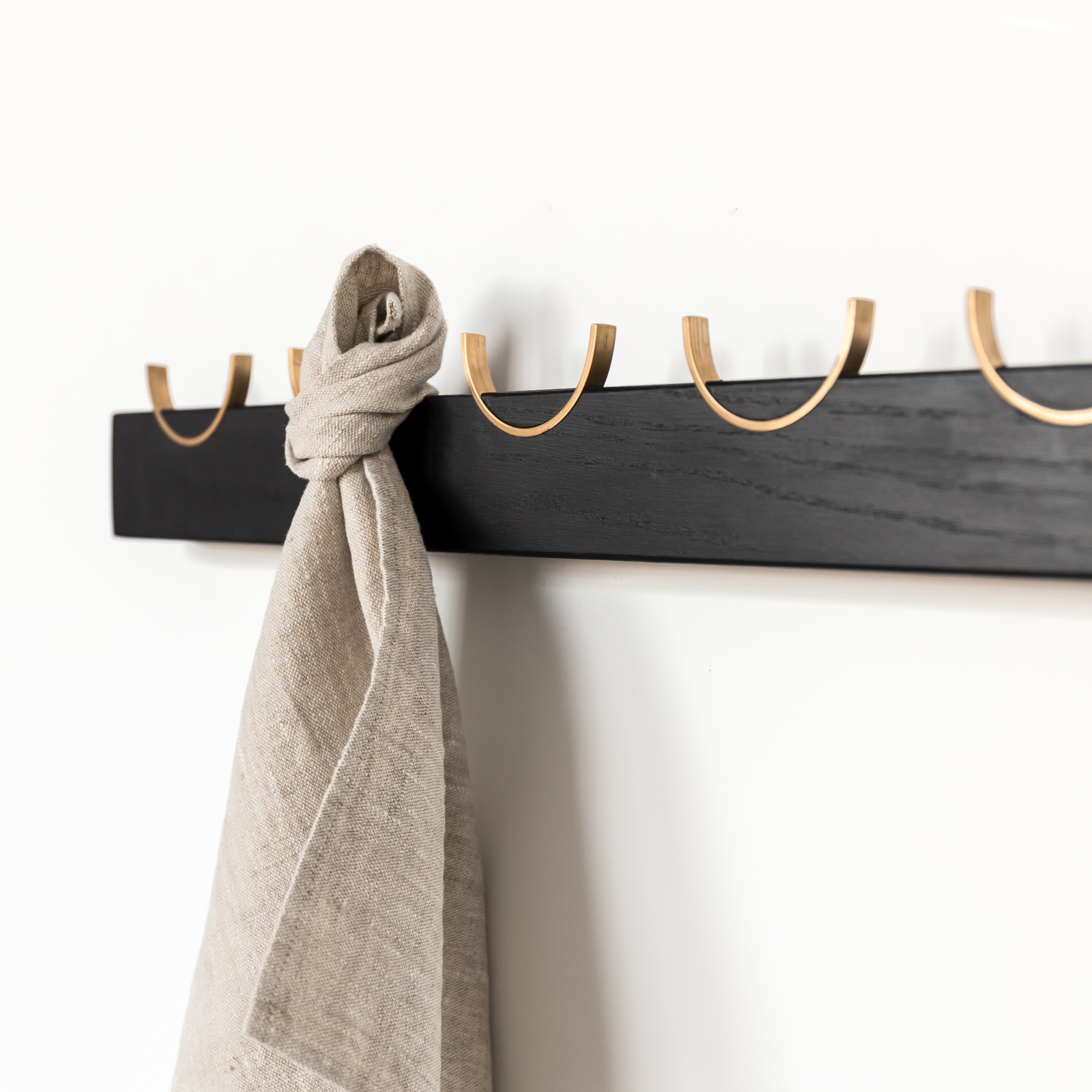 Black wall towel rack with brass