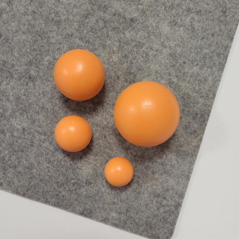 Orange knobs for nursery furniture